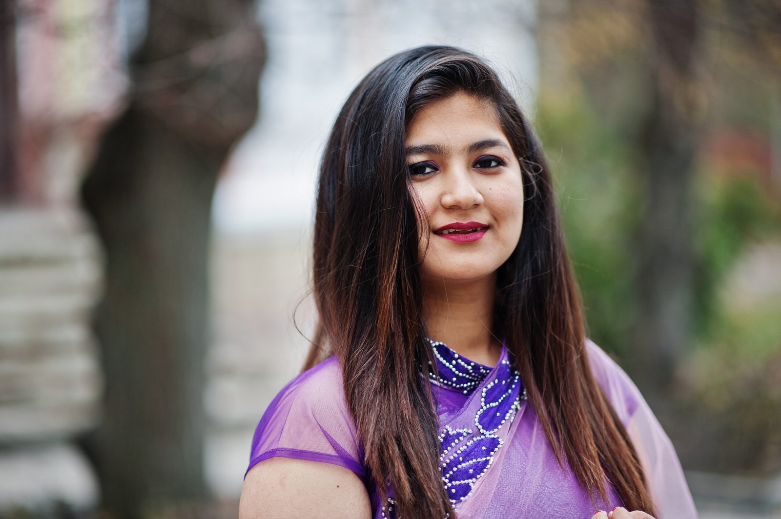 close up portrait of indian hindu girl at traditional violet sar